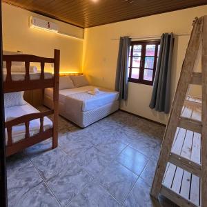 a room with two bunk beds and a window at Pousada Samburá in Garopaba +43 photos