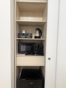 a microwave oven sitting inside of a kitchen cabinet at Arena Paris La Défense in Nanterre