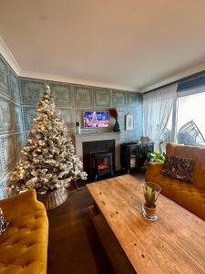 a living room with a christmas tree and a couch at Dog-friendly Seaview Apartment in Dungarvan