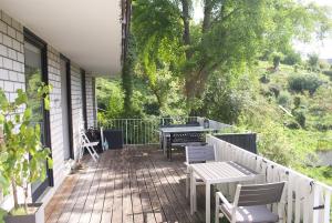a porch with a table and chairs on a house at Apartment in Heidelberg with Neckar view in Niederdorla