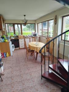 a kitchen with a table and chairs in a room at Вила Релакс in Pleven