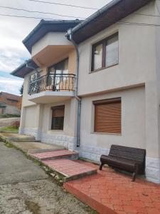 a house with a bench in front of it at Вила Релакс in Pleven +2 photos