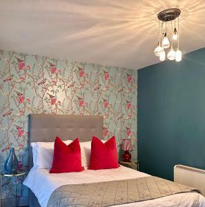 a bedroom with a bed with red pillows at Dog-friendly Seaview Apartment in Dungarvan
