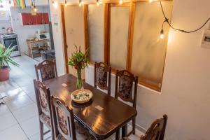 a dining room with a table and chairs with a bowl on it at Carmen Alto Inn Charming Private Rooms Steps from Downtown in Cusco
