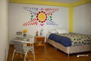 a bedroom with a bed with a painting on the wall at Carmen Alto Inn Charming Private Rooms Steps from Downtown in Cusco