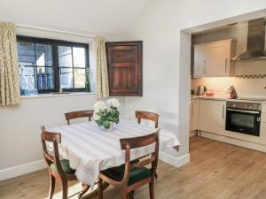 a kitchen and dining room with a table and chairs at Keepers Cottage in Warminster