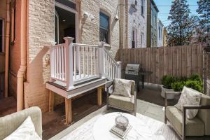 a patio with chairs and a staircase on a house at Premier 5BR Historic Victorian Townhouse in Washington
