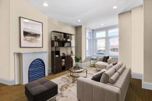 a living room with a couch and a fireplace at Premier 5BR Historic Victorian Townhouse in Washington