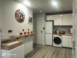 a kitchen with a white refrigerator and a washing machine at Pensión Guggenheim Riverview HBI01297 in Bilbao