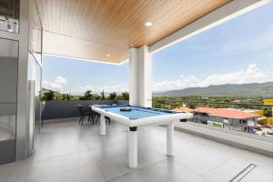 a pool table on the balcony of a house at Hotel H4 Olanchito in Olanchito