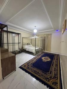 Una habitación grande con una cama y una alfombra azul. en Express at home, en Dakar