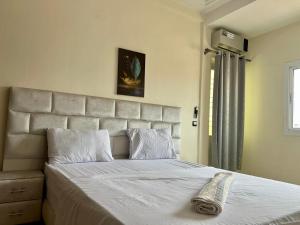 a bedroom with a large bed with a large headboard at Appart Hotel Fes - Joud Families & Travelers in Fez +15 photos