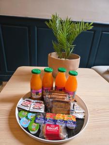 a tray of drinks and snacks on a table at Le Parisien in Le Mans