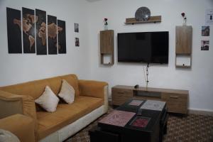 a living room with a couch and a flat screen tv at Petra entrance Apartment in Petra