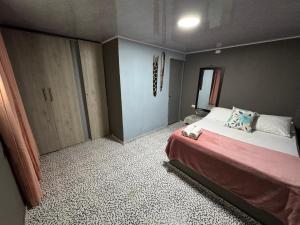 Ένα ή περισσότερα κρεβάτια σε δωμάτιο στο Casa Rodadero