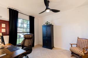 ein Wohnzimmer mit einem Schreibtisch und einem Deckenventilator in der Unterkunft Newer 3 Bed 2Bath Home-Near USSSA Complex and Beach in Rockledge + 28 Fotos