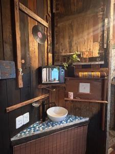 a small bathroom with a toilet and a tv at La mar in La Pedrera +22 photos