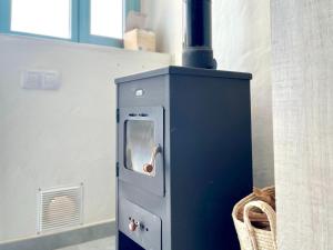 a stove in a kitchen next to a wall at Cave Houses Ed, Yara and Nadieh with PRM facilities in Margen de Abajo