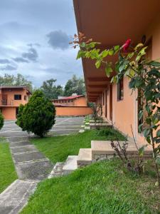 a courtyard of a building with stairs and grass at HOTEl CHAIS in Colorines