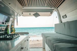 an rv with a view of the beach and the ocean at Mini Camper Van Hot Water, You Can Drive it in Telde