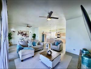 a living room with a couch and a table at Zirok Villas in The Valley