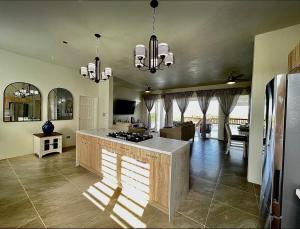 a kitchen with a island in the middle of a room at Zirok Villas in The Valley