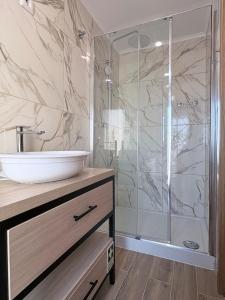 a bathroom with a sink and a shower at Figueira Guesthouse in Figueira da Foz