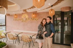 a man and woman standing in front of a restaurant at Estancia del Alba in Cajamarca