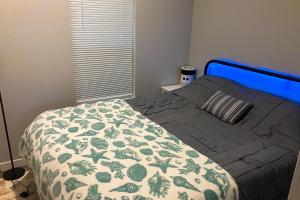 a bedroom with a bed with a blue head board at Tiny Lake Retreat in Sagle