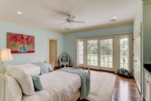 a bedroom with two beds and a ceiling fan at GE317: 317 Glen Eagle in Kiawah Island +40 photos