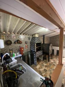 a kitchen with a sink and a stove in a room at Recanto da Magia in Palhoça