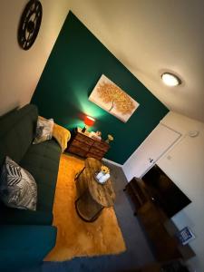 a living room with a couch and a table at Harbour Lights Retreat-Small and Cosy 1 bedroom in Ferryden