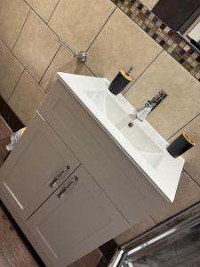 a bathroom with a white sink and a counter at Harbour Lights Retreat-Small and Cosy 1 bedroom in Ferryden