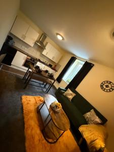 a living room with a couch and a table at Harbour Lights Retreat-Small and Cosy 1 bedroom in Ferryden