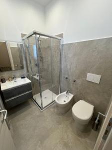 a bathroom with a shower and a toilet and a sink at G&Ghomeciampinosuite in Ciampino