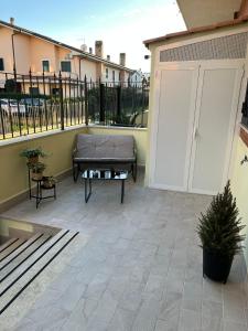 a patio with a couch and a table at G&Ghomeciampinosuite in Ciampino