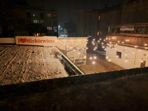 a building with christmas lights on it at night at Poznaj Mickiewicza 4 in Racibórz