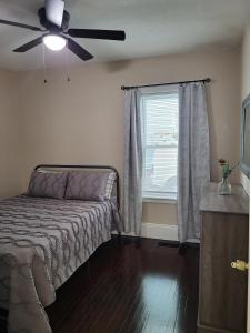 a bedroom with a bed and a ceiling fan at Apt 1 Stylish First Floor Apartment in Worcester
