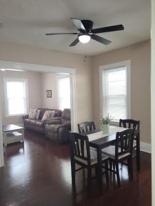 a living room with a table and a ceiling fan at Apt 1 Stylish First Floor Apartment in Worcester
