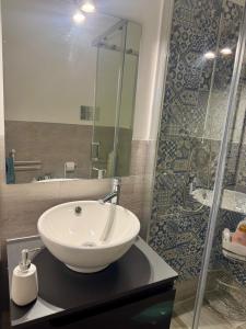 a bathroom with a sink and a shower at Anastasia's House in Palermo +8 photos