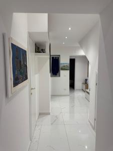 a white hallway with white walls and white tile floors at Anastasia's House in Palermo