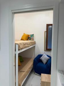 a room with a bunk bed and a blue couch at Anastasia's House in Palermo