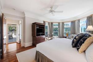 Un dormitorio con una cama grande y un televisor. en FW126: 126 Flyway Drive, en Kiawah Island
