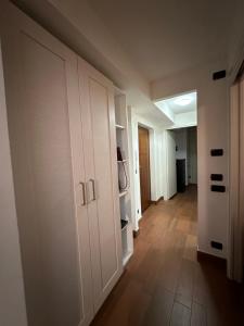 a hallway with white cabinets and a room with a floor at 1000sogni in Limone Piemonte +22 photos