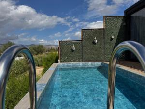 a swimming pool in the middle of a house at majestic tiny home with private pool in Trikomo