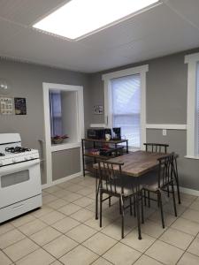 a kitchen with a table and chairs and a stove at Apt 2 2nd Floor in the Heart of the City in Worcester