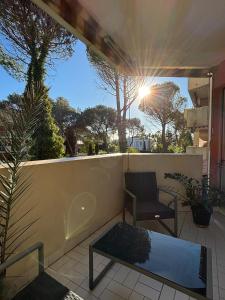 a patio with a bench and a chair on a balcony at SeaNest Le Nid Marin in Saint-Raphaël
