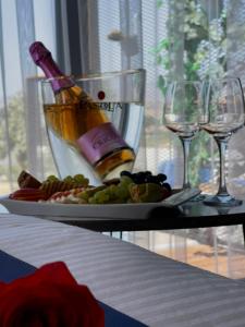 a table with a bottle of champagne and wine glasses at majestic tiny home with private pool in Trikomo