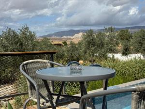a table and chairs on a balcony with a view at majestic tiny home with private pool in Trikomo