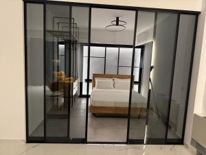 a bedroom with a bed in a room with glass walls at You and the view in Mytilene